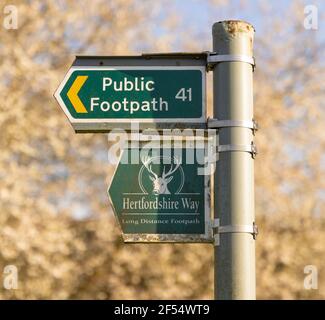 Public footpath sign and Hertfordshire Way sign on a post in the countryside. Hertfordshire, UK. Stock Photo