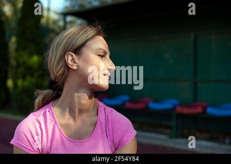 The athlete sits and normalizes her body after a strenuous workout Stock Photo