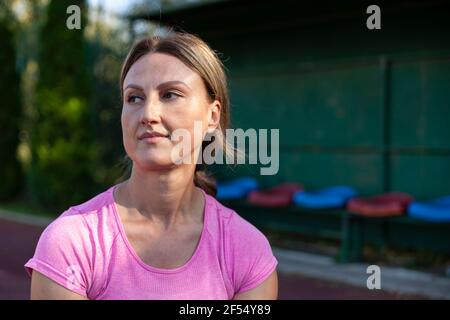 The athlete sits and normalizes her body after a strenuous workout Stock Photo