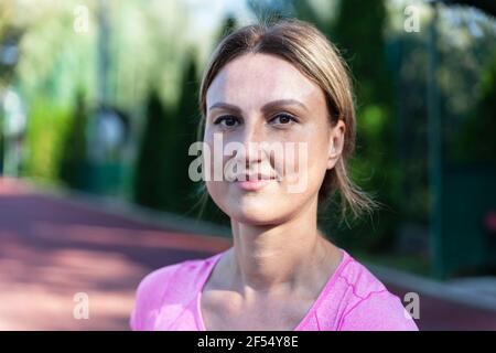 The athlete sits and normalizes her body after a strenuous workout Stock Photo