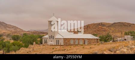 White Church from Town Aus, Namibia, background cloudy sky, Namib Naukluft Rand Stock Photo