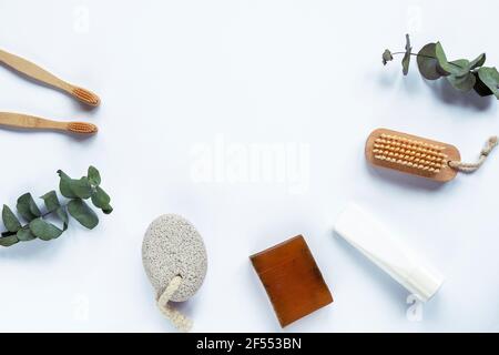 Natural accessories for personal care, personal hygiene items flat lay on white background. Toothbrushes, body brush, pumice stone, soap bar, cream tu Stock Photo