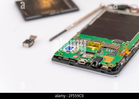 Repair the mobile phone on the white table copy space. Stock Photo