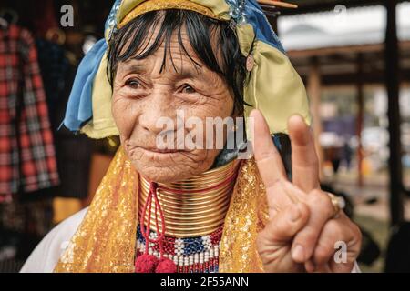 Loikaw, Myanmar - May 25, 2016: Portrait of Padaung (Karen) long neck woman in brass rings around neck and traditional clothing on Deenawso market Stock Photo