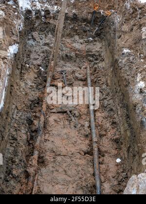 Civil infrastructure pipe, water lines and storm sewers. a pit dug for the repair and replacement of utilities. Stock Photo