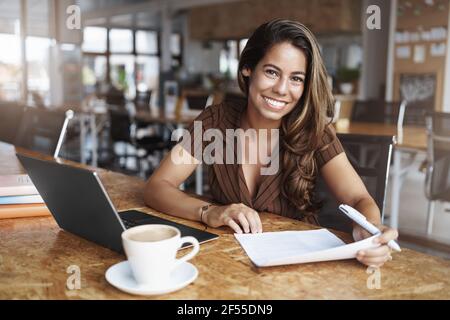 Woman discuss business with you. Pleasant smiling charming businesswoman meeting business partners co-working urban space drinking coffee discuss Stock Photo