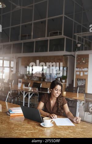 Vertical shot successful lucky businesswoman liking run business prepare papers researching reading important documentation smiling satisfied good Stock Photo