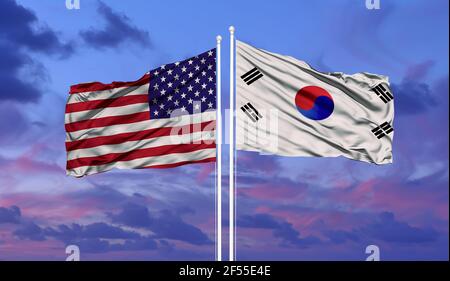 South Korea and United States two flags on flagpoles and blue cloudy sky Stock Photo