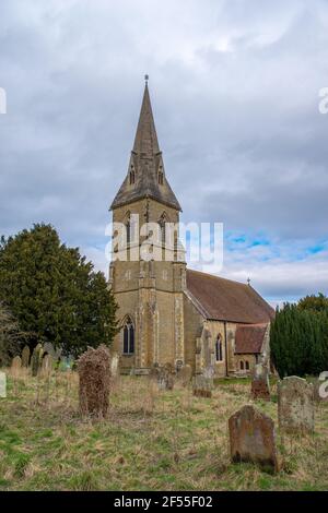 Warter, East Yorkshire, England, 23 March 2021 - St James Church and grave stones in an overgrown  church yard. Stock Photo