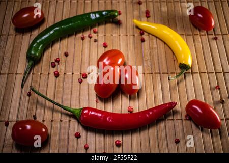 Chilli pepper an cherry tomatoes background. Stock Photo