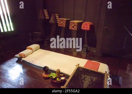 A simple, humble, sleeping, bed area at Kamthieng House Museum, a Northern Thai traditional raised wooden teak rural house. In Bangkok, Thailand. Stock Photo