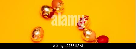 Happy Easter web banner. Golden chicken eggs on a yellow background. Top view, flat lay with copy space. Stock Photo