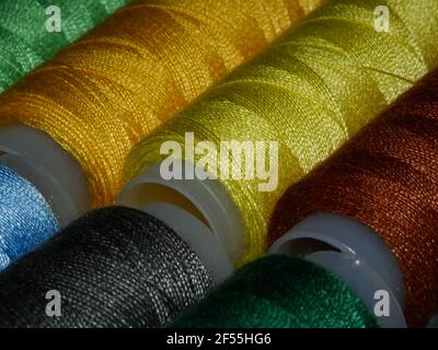 Sewing threads multicolored background closeup Stock Photo