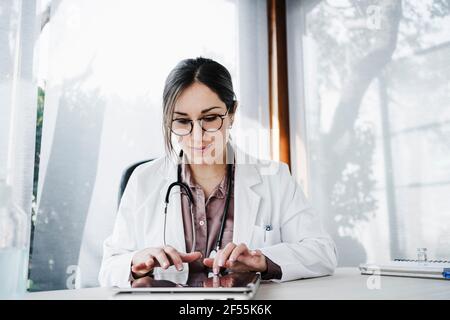 Female doctor working on digital tablet in hospital Stock Photo