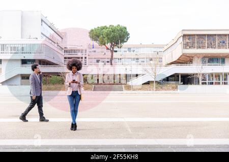 Graphic visualization of data exchanged by man and woman using smart phones outdoors Stock Photo
