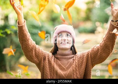 Smiling woman in knit hat enjoying autumn day Stock Photo