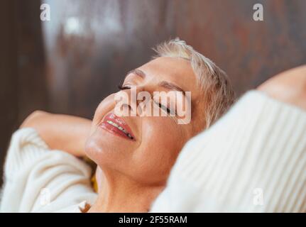 Beautiful senior woman with eyes closed relaxing Stock Photo
