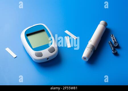 glucometer ketometer lancet and strips for self-monitoring of blood glucose or ketones level. diabetes or keto diet Stock Photo