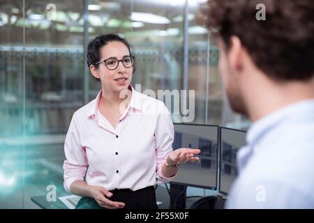 Male and female entrepreneur discussing at office Stock Photo