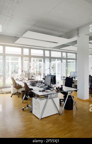 Desks, chairs and computers in office Stock Photo