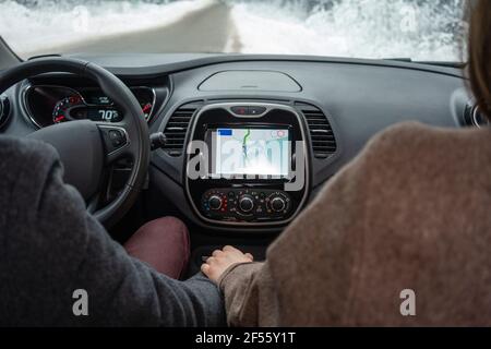 Couple using car navigational system while sitting in car Stock Photo