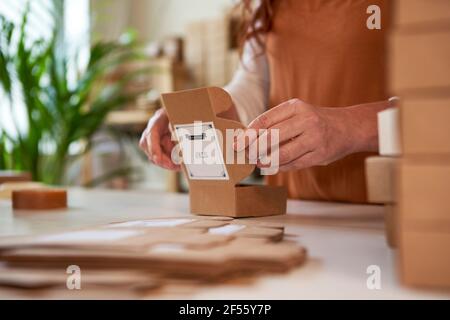 Woman folding boxes for packaging of handmade soaps Stock Photo