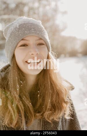 Portrait of beautiful teenage girl wearing knit hat smiling at camera Stock Photo