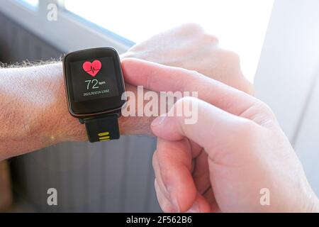 Smart technologies. A person adjusts the settings of a sports watch for outdoor training. Stock Photo