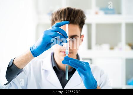 Young scientist making chemical in laboratory Stock Photo