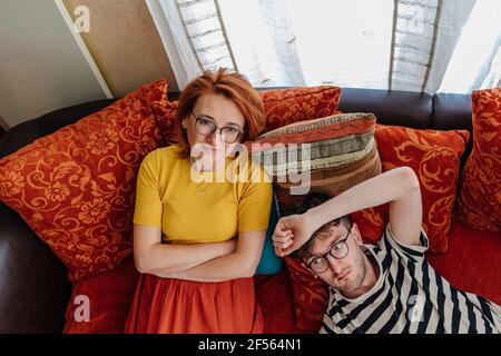 Thoughtful mother and son relaxing on sofa at home Stock Photo
