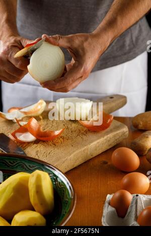 Mid section of man peeling onion Stock Photo