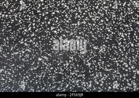 clean surface of a frying pan with a non-stick coating of dark color with a speck close-up, the texture of the coating of kitchen utensils. Stock Photo