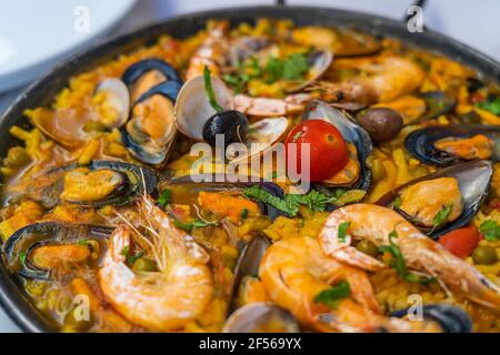 Spanish seafood Paella de Marisco, Paella Marinera with mussels, shellfish and scampis Stock Photo