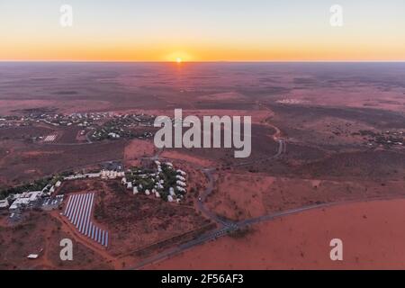 Australia, Northern Territory, Yulara, Aerial view of desert town in Uluru-Kata Tjuta National Park at sunrise Stock Photo