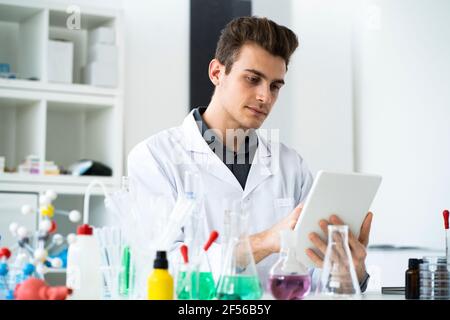 Male scientist using digital tablet while working in laboratory Stock Photo