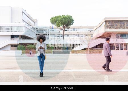 Graphic visualization of data exchanged by man and woman using smart phones outdoors Stock Photo