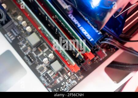 the inserting plug in the ram ddr memory card in the computer mainboard, random access memory Stock Photo