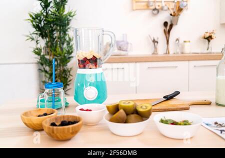 Various fruits in bowl on table at home Stock Photo