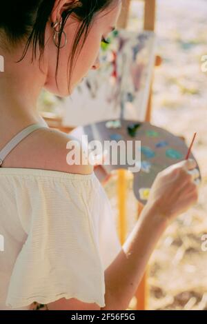 Young woman artist with paint and palette Stock Photo