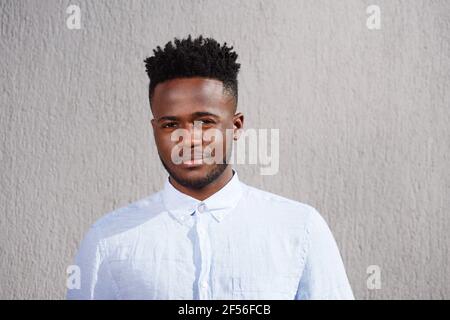 Close up portrait of handsome young african man with beard standing looking serious Stock Photo