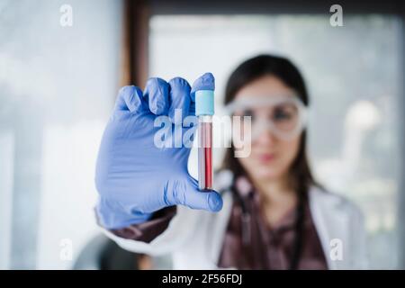 Blood sample held by female doctor in hospital Stock Photo