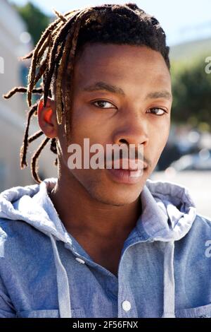 Close up portrait of african man with dreadlocks staring outside Stock Photo