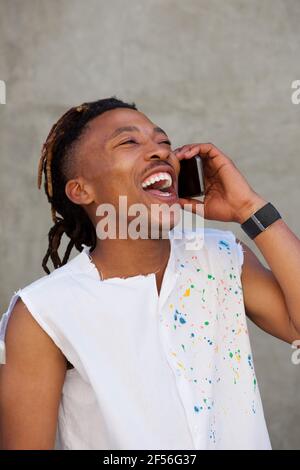 Portrait of african man  laughing and talking on cellphone Stock Photo