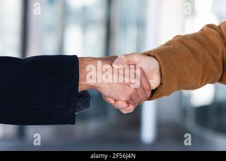 Business partners shaking hands outdoors Stock Photo