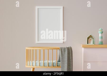 Three dimensional render of blank picture frame hanging on wall over empty crib Stock Photo