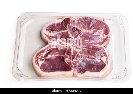 Raw lamb  chops in vacuum package isolated on white Stock Photo