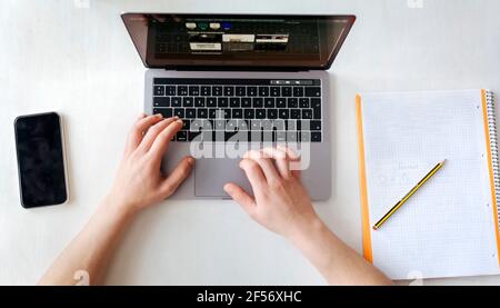 Man using laptop on desk at home office Stock Photo