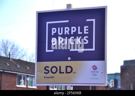 A Purple Bricks estate agent 'sold' sign outside a house in Manchester, England, United Kingdom.