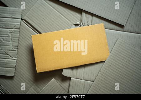 A saturated brown cardboard on a heap of cardboards. Stock Photo