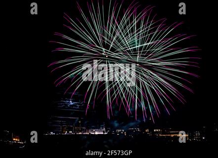 Fireworks over Parliament Hill with the full moon peeking through the clouds Stock Photo